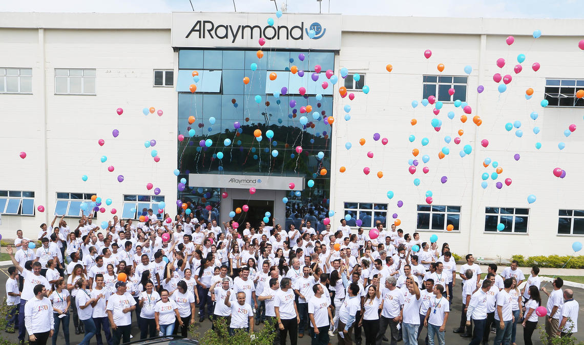 Employees in front of the ARaymond building, in Brazil